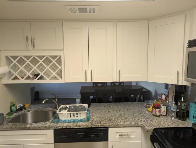 a kitchen with stainless steel appliances granite countertop a stove and a refrigerator