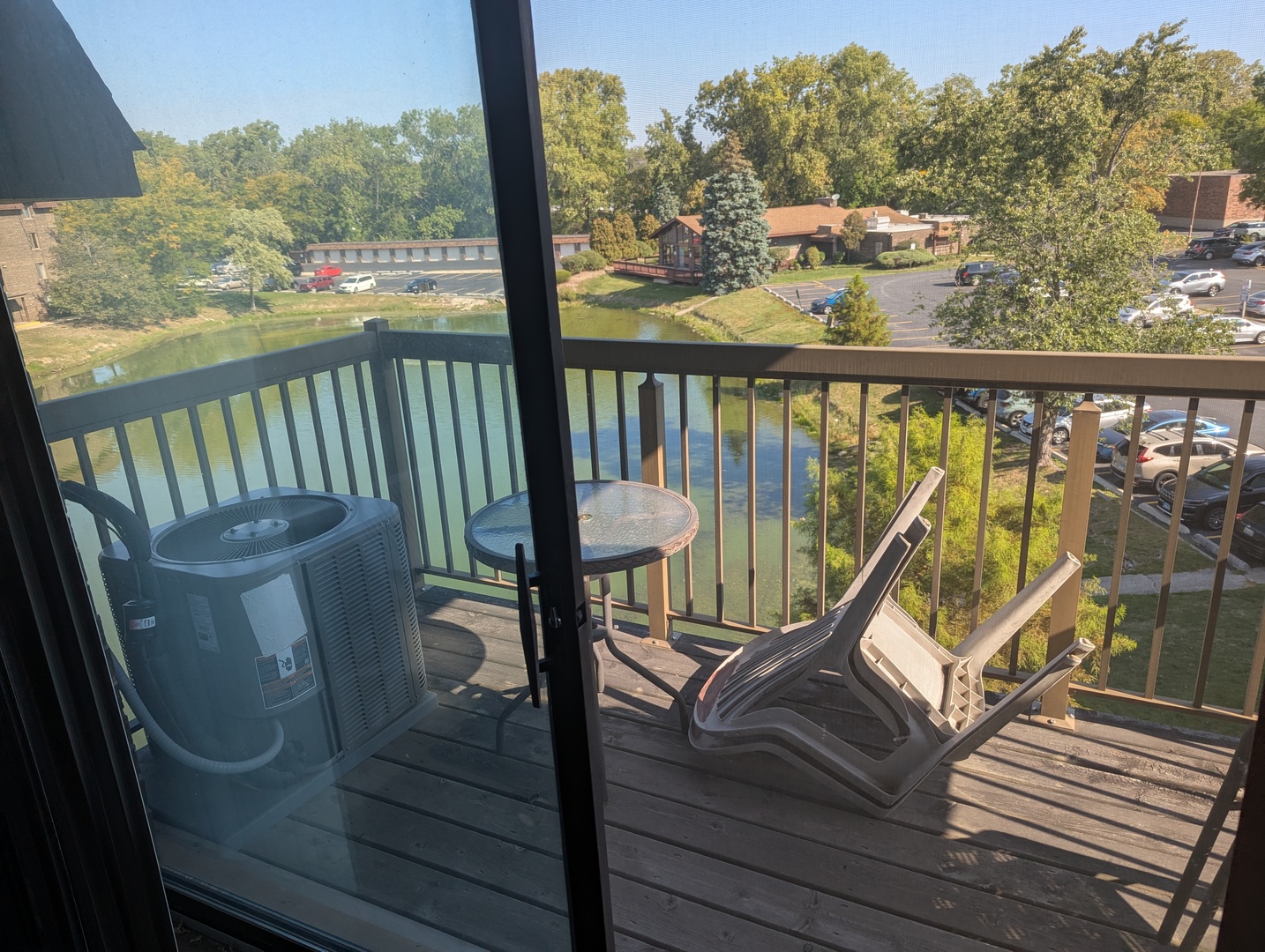820 Elder Road, Unit 416 Homewood, IL 60430 - Photo 8 of 10 a view of a balcony with wooden floor and outdoor seating