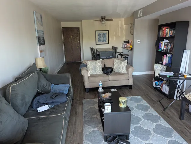 a view of a dining room with furniture and a chandelier fan
