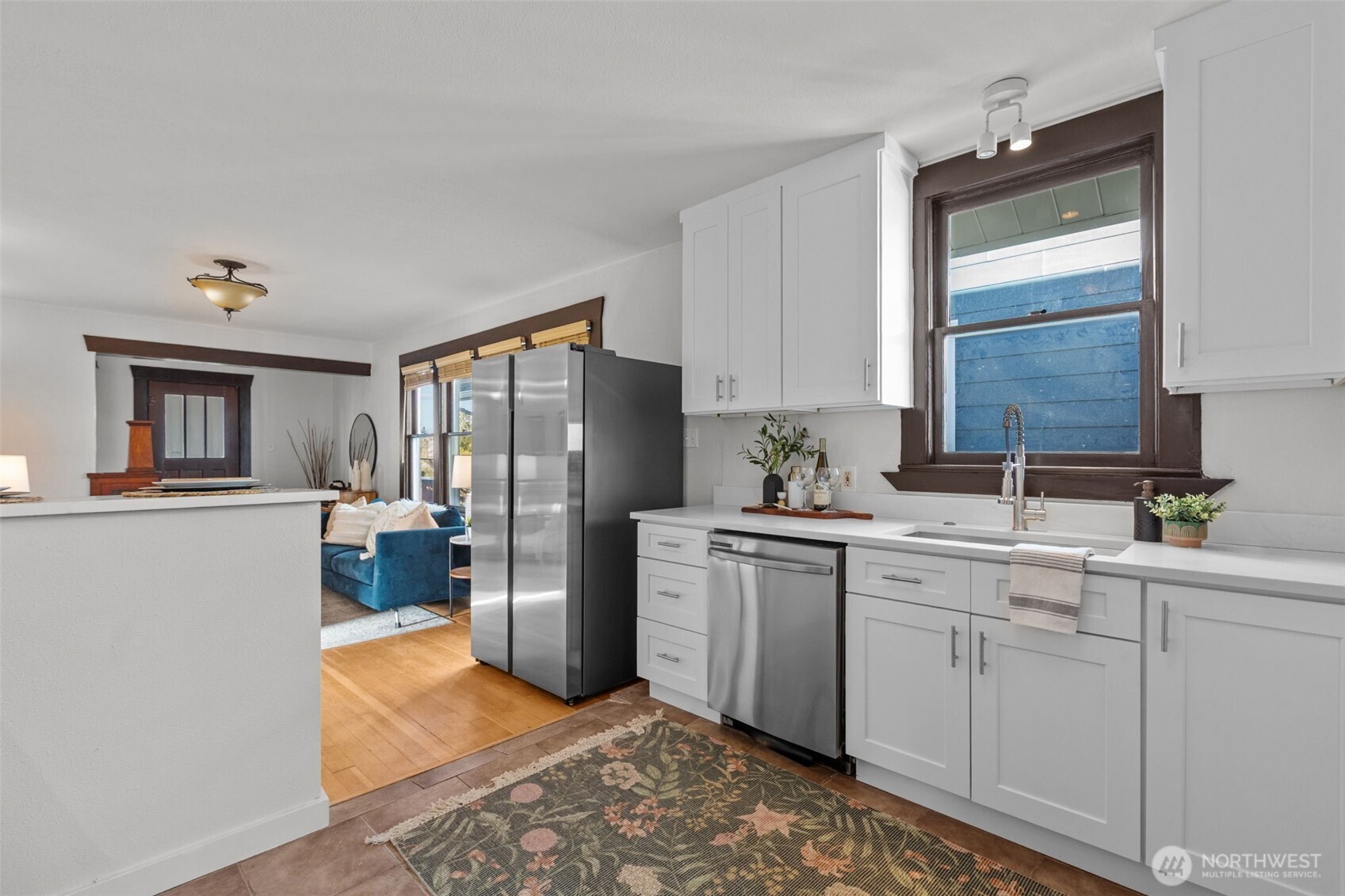 4219 South Mead Street Seattle, WA 98118 - Photo 12 of 40 a kitchen with a refrigerator sink and cabinets