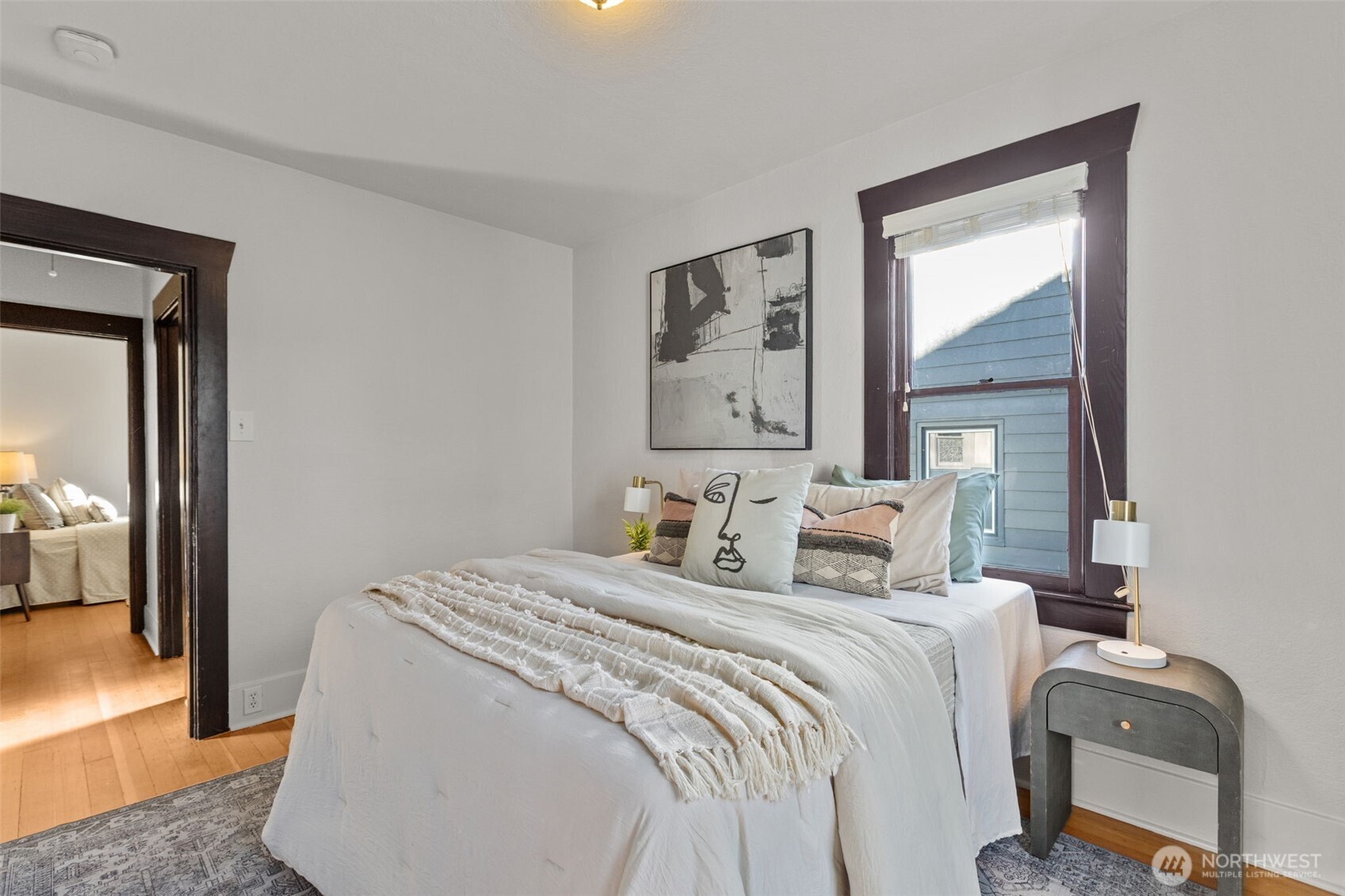 4219 South Mead Street Seattle, WA 98118 - Photo 16 of 40 a bedroom with a bed and a painting on the wall
