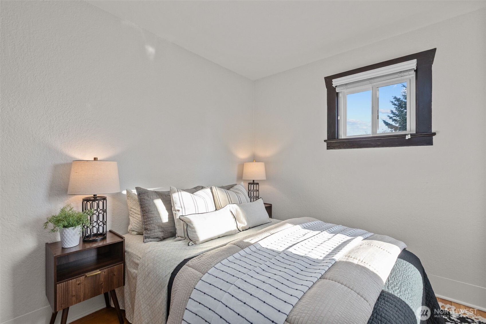 4219 South Mead Street Seattle, WA 98118 - Photo 20 of 40 a bedroom with a bed and a painting on the wall