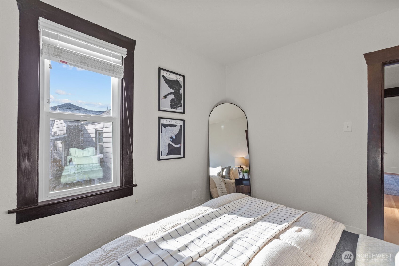 4219 South Mead Street Seattle, WA 98118 - Photo 22 of 40 a bedroom with a bed and a painting on the wall