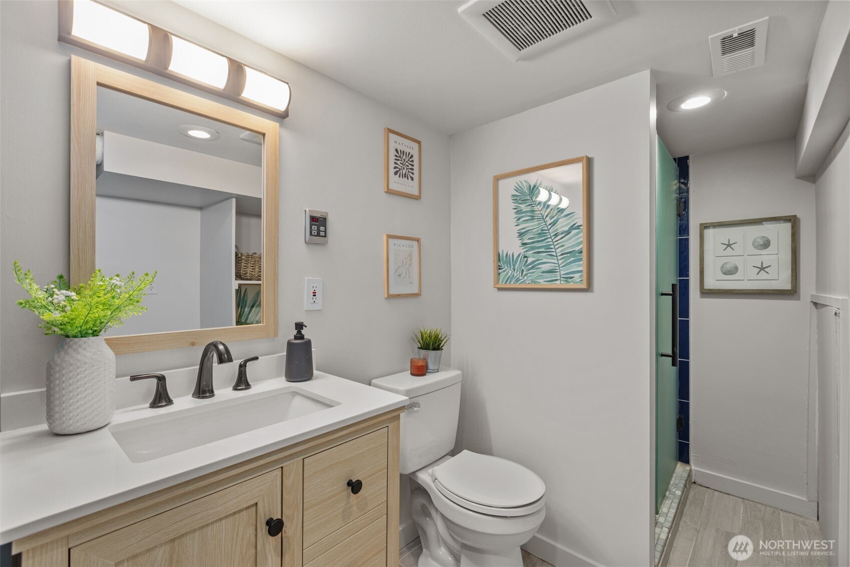 4219 South Mead Street Seattle, WA 98118 - Photo 28 of 40 a bathroom with a toilet a sink and mirror