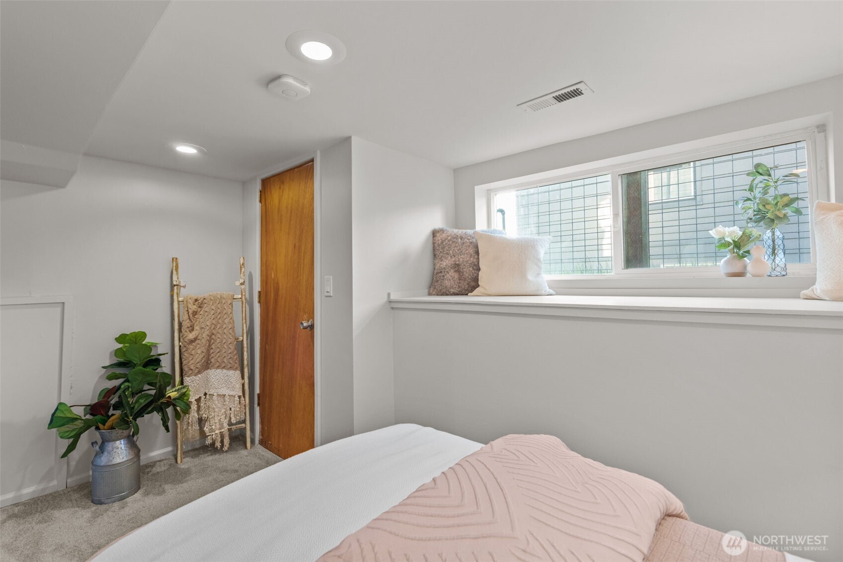 4219 South Mead Street Seattle, WA 98118 - Photo 32 of 40 a bedroom with a large bed and a potted plant