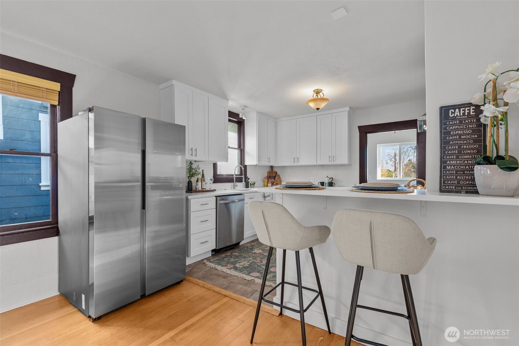 4219 South Mead Street Seattle, WA 98118 - Photo 8 of 40 a kitchen with stainless steel appliances a refrigerator sink and microwave