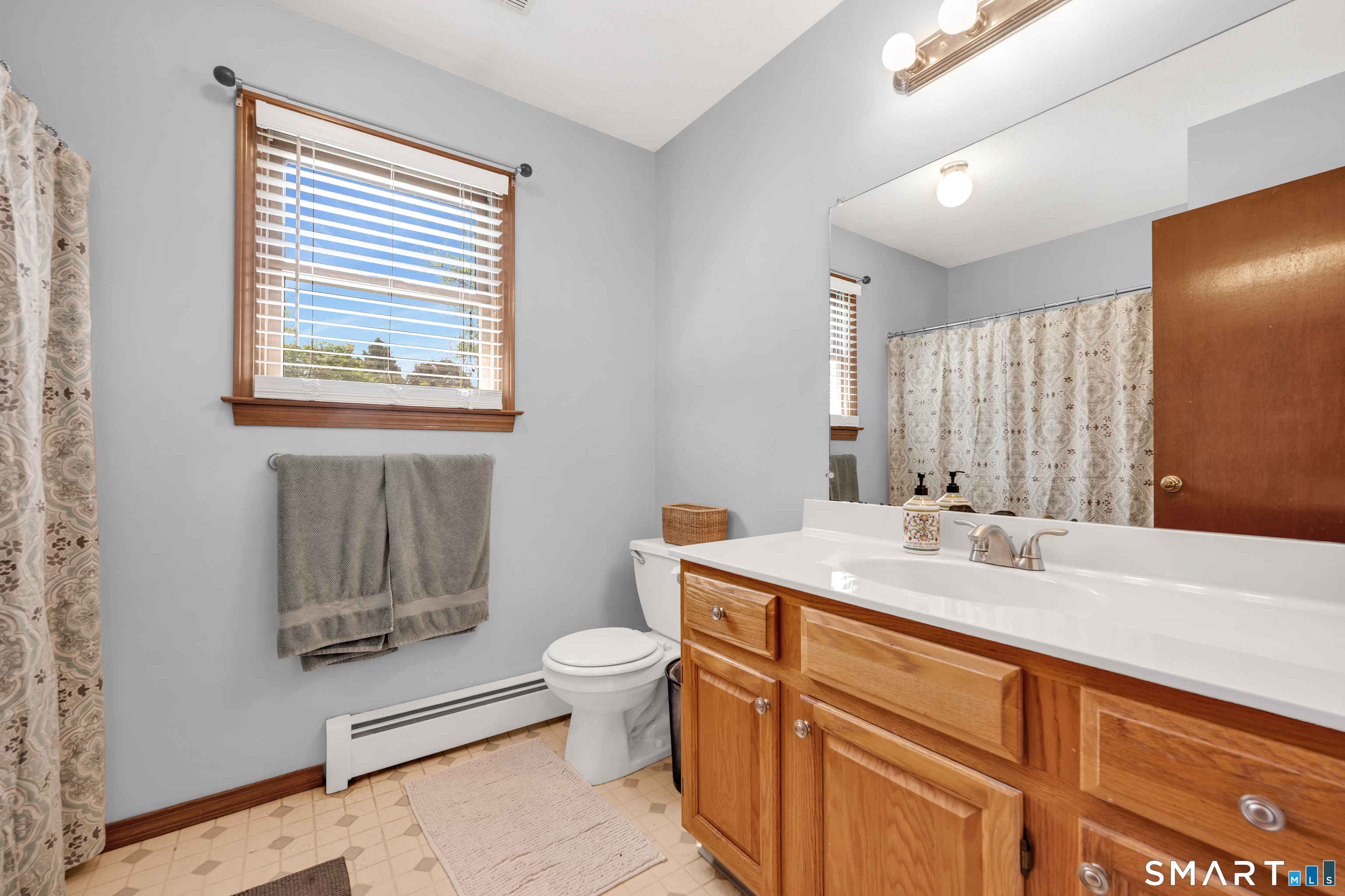 89 Windsorville Road South Windsor, CT 06074 - Photo 10 of 23 a bathroom with a granite countertop sink mirror vanity and toilet