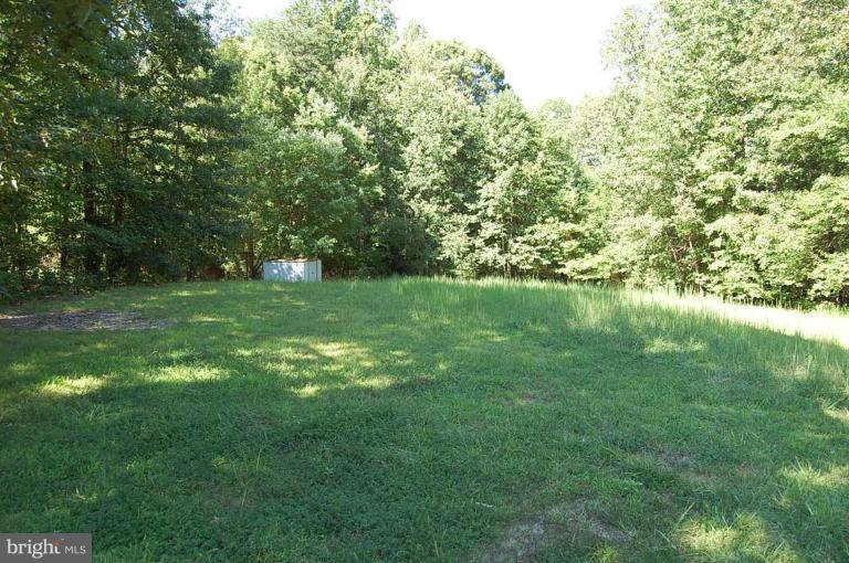 Large 1 acre lot backing to trees