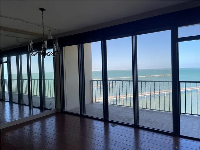 a view of a room with wooden floor