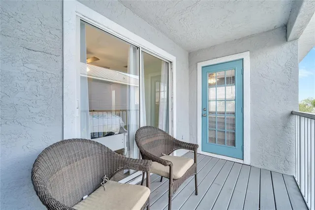 an aerial view of a house with swimming pool and outdoor seating