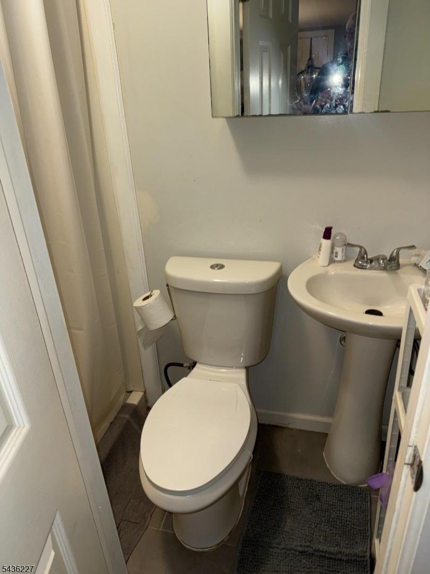 218 Bell Avenue Lodi, NJ 07644 - Photo 12 of 14 a bathroom with a toilet and a sink