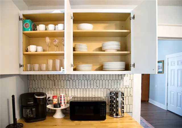 a kitchen with a table and a fireplace