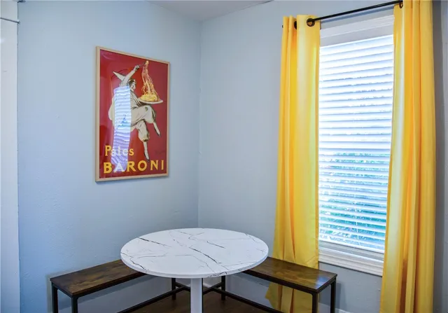 a view of a room with a table and a chair