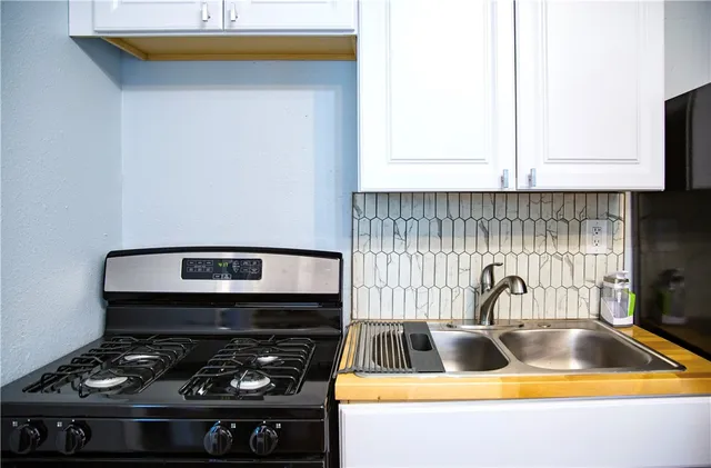 a kitchen with a stove and a sink