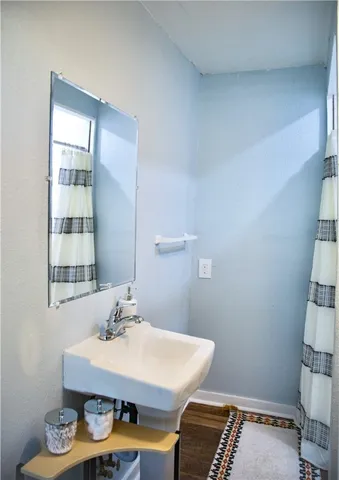 a room with a table chairs and a window