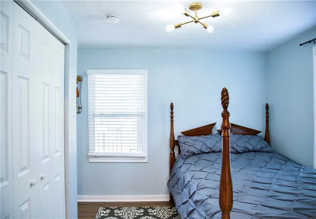 a bedroom with a bed and window