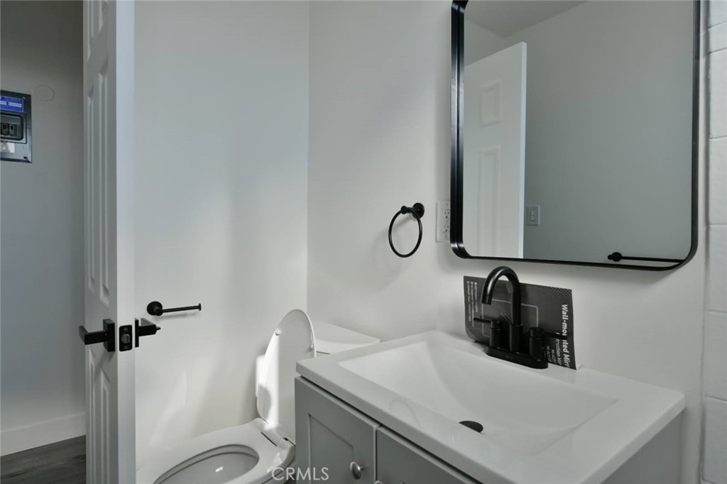 6221 Corona Avenue Bell Gardens, CA 90201 - Photo 12 of 65 a bathroom with a sink toilet and a mirror