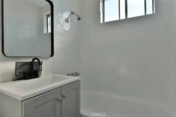 a bathroom with a bathtub and sink