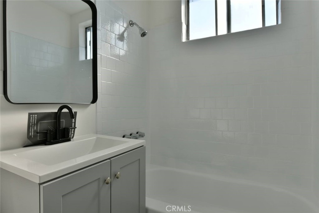 6221 Corona Avenue Bell Gardens, CA 90201 - Photo 13 of 65 a bathroom with a sink and a mirror