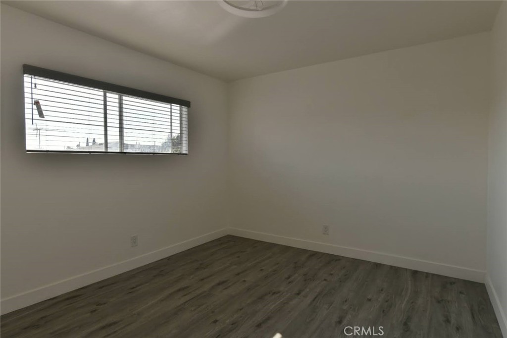 6221 Corona Avenue Bell Gardens, CA 90201 - Photo 15 of 65 an empty room with wooden floor and windows