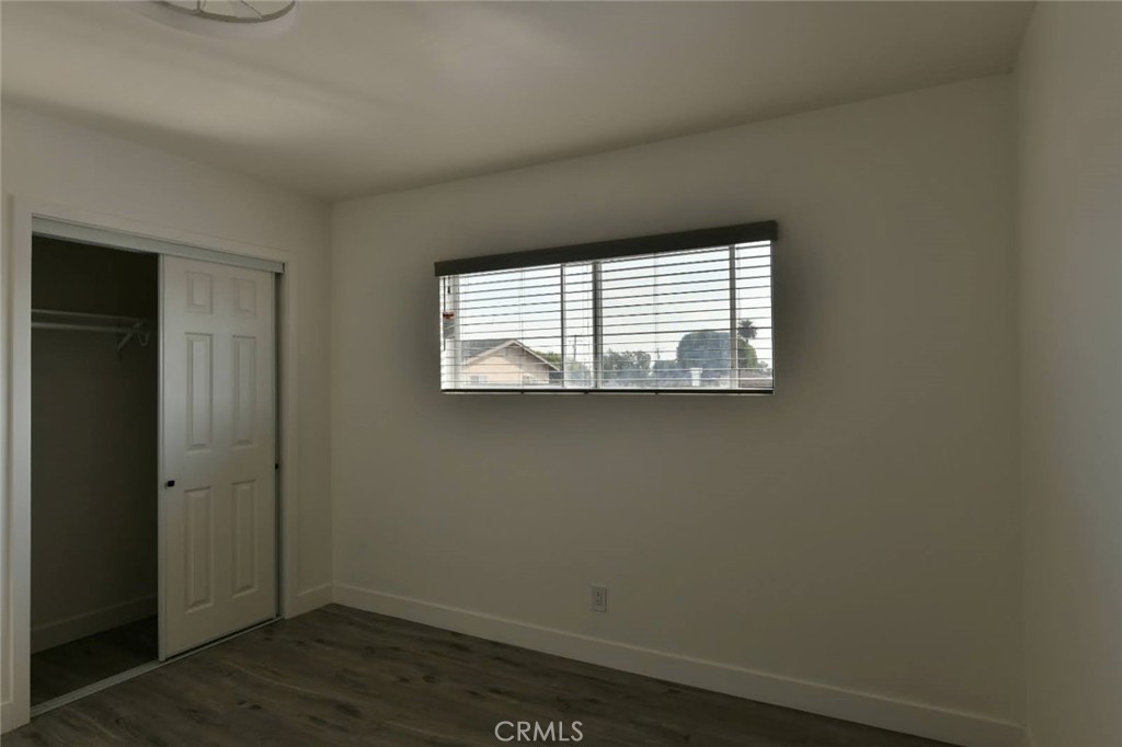 6221 Corona Avenue Bell Gardens, CA 90201 - Photo 17 of 65 an empty room with wooden floor and a window