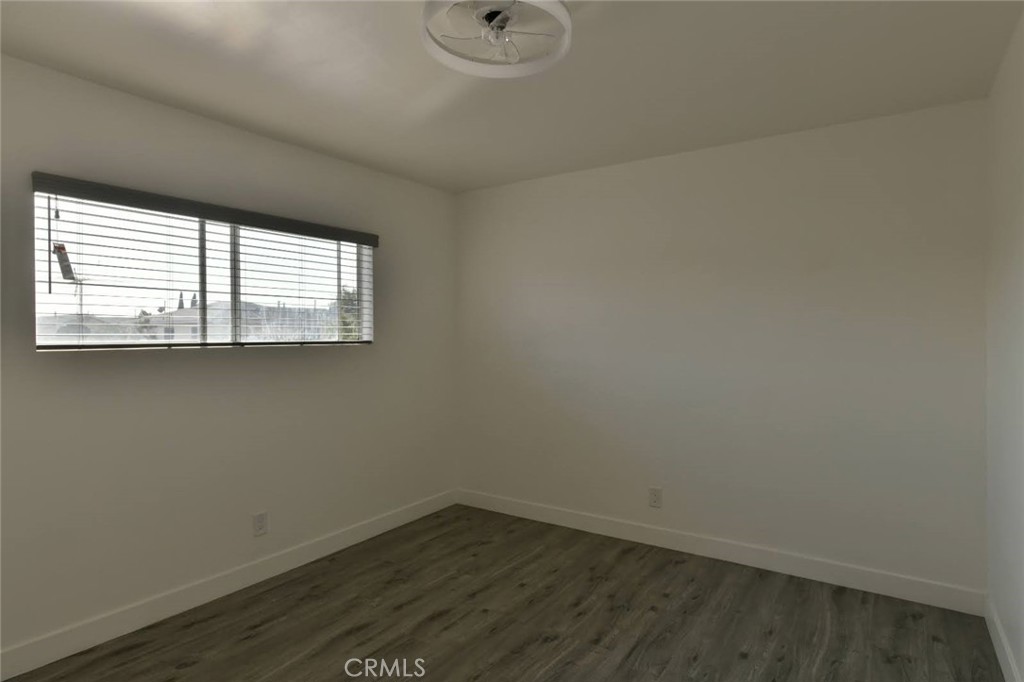 6221 Corona Avenue Bell Gardens, CA 90201 - Photo 18 of 65 an empty room with wooden floor and windows