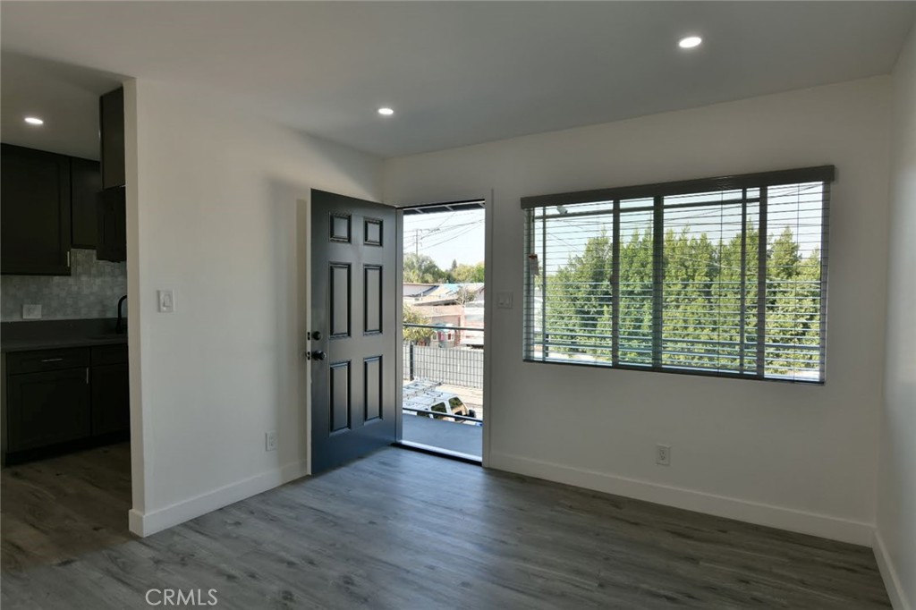 6221 Corona Avenue Bell Gardens, CA 90201 - Photo 21 of 65 an empty room with wooden floor and windows
