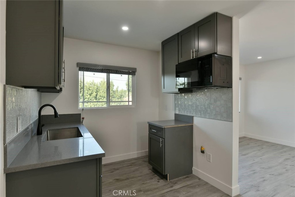 6221 Corona Avenue Bell Gardens, CA 90201 - Photo 25 of 65 a kitchen with a sink cabinets and a window
