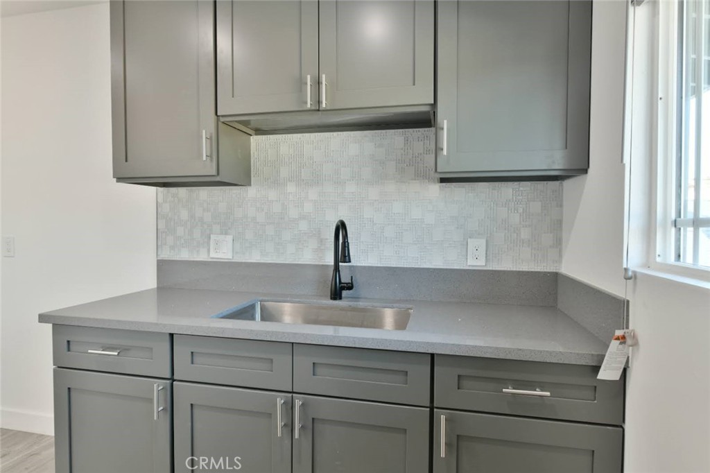 6221 Corona Avenue Bell Gardens, CA 90201 - Photo 27 of 65 a kitchen with a sink and cabinets