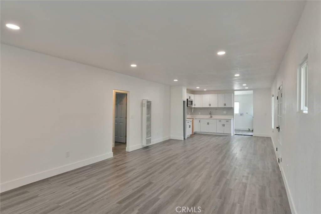 6221 Corona Avenue Bell Gardens, CA 90201 - Photo 37 of 65 a view of a big room with wooden floor and windows