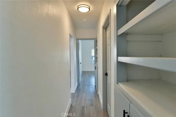 a view of room with wooden floor and windows