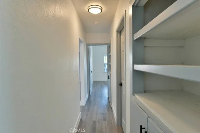 a view of room with wooden floor and windows