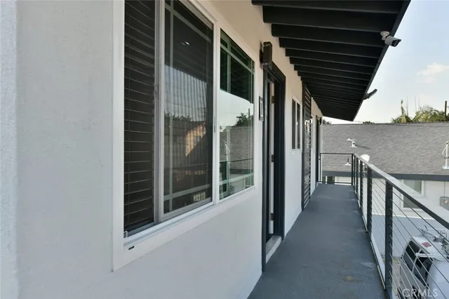 a view of a hallway with wooden fence