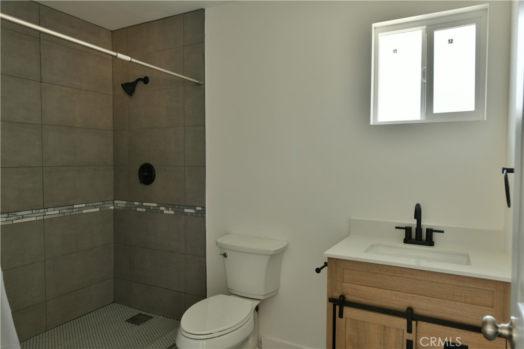 6221 Corona Avenue Bell Gardens, CA 90201 - Photo 61 of 65 a bathroom with a shower a toilet and sink