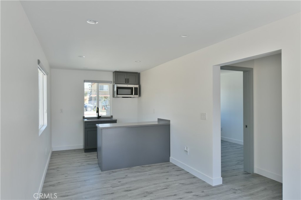 6221 Corona Avenue Bell Gardens, CA 90201 - Photo 65 of 65 a view of a kitchen with wooden floor and electronic appliances