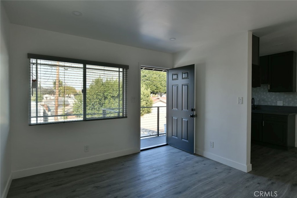 6221 Corona Avenue Bell Gardens, CA 90201 - Photo 8 of 65 an empty room with wooden floor and windows
