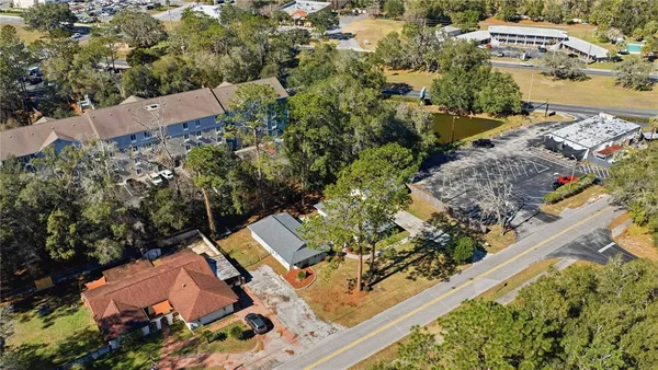 an aerial view of a house with a garden and trees