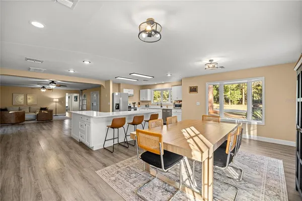a large white kitchen with a large window