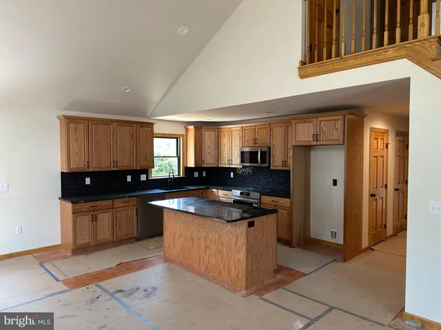 a kitchen with granite countertop a sink and a stove
