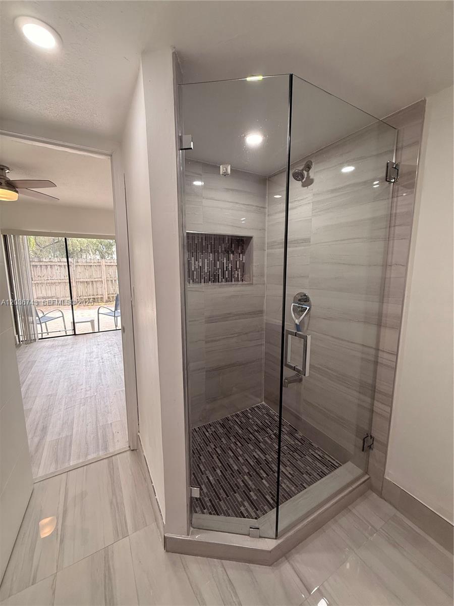 10875 Northwest 7th Street, Unit 1136 Miami, FL 33172 - Photo 21 of 25 a bathroom with a glass shower door