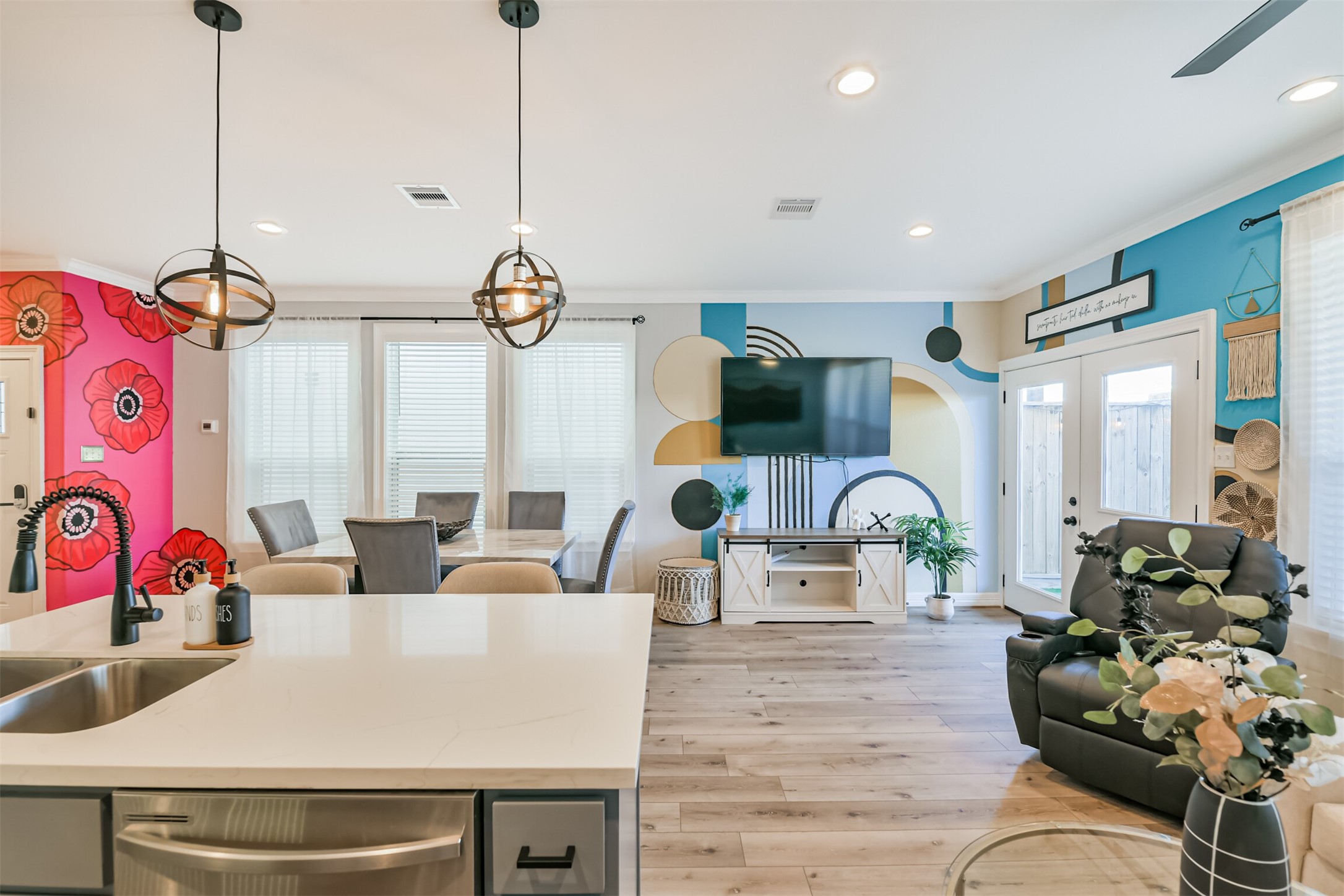 a living room with furniture kitchen view and a large window