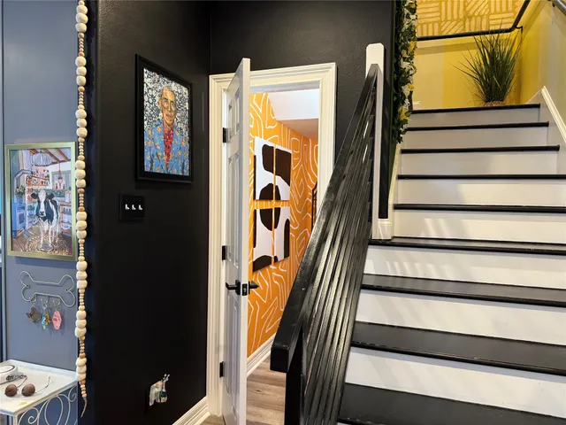 a view of staircase with wooden floor and a potted plant