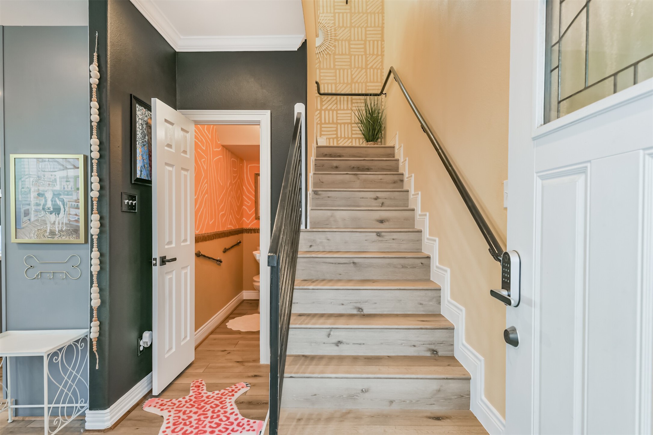 1010 Melneeka Lane Houston, TX 77091 - Photo 5 of 37 As you enter through the front door you'll see the powder room, staircase, and garage door.