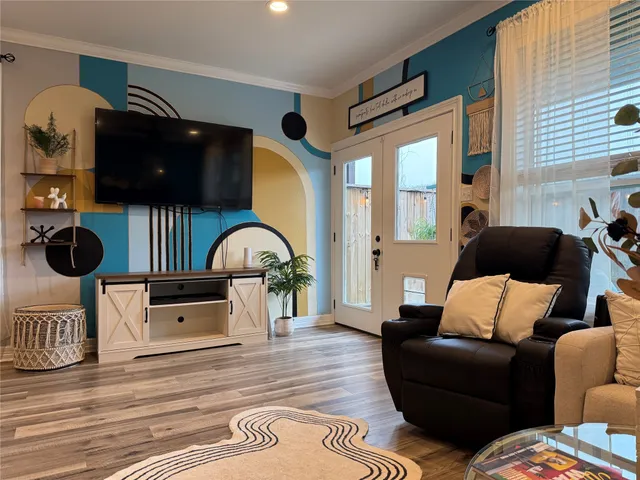 a living room with furniture and a large window