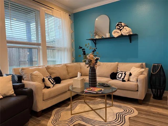 a view of a patio with couches table and chairs and potted plants