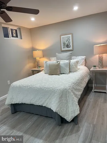 a large bed sitting in a bedroom next to a lamp