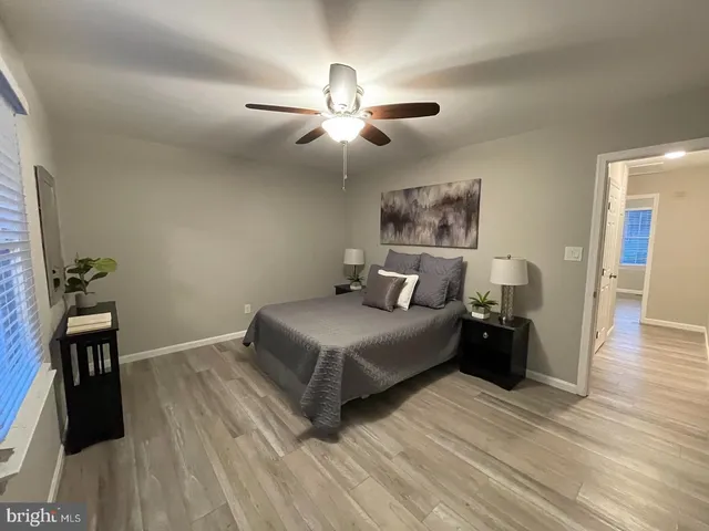 a bedroom with a bed and a ceiling fan