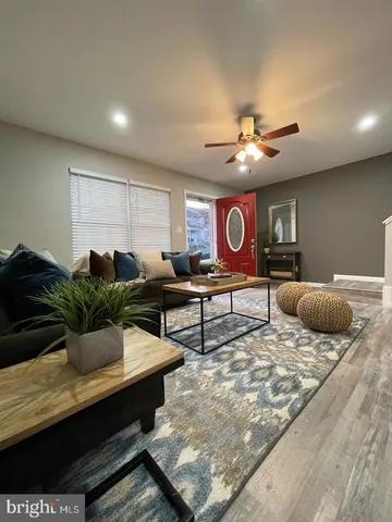 a living room with furniture and a chandelier