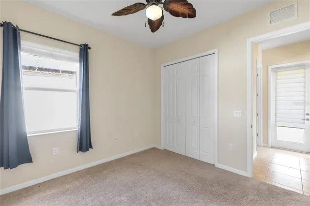 an empty room with windows and closet