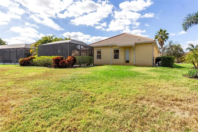 a view of a house with a yard and potted plants